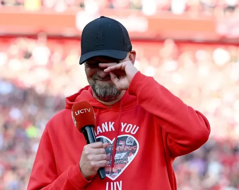 Cổ động viên Liverpool hát vang You'll Never Walk Alone tại sân Anfield trước trận đấu với khăn quàng giơ cao